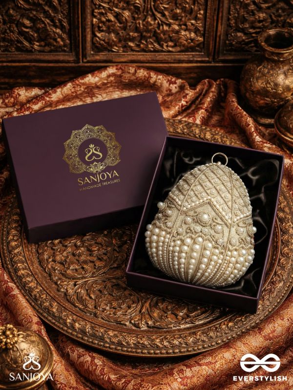 SAHIBA  – OVAL IVORY SILK CLUTCH WITH PEARL EMBEDDING AND GOLDEN METAL FRAME