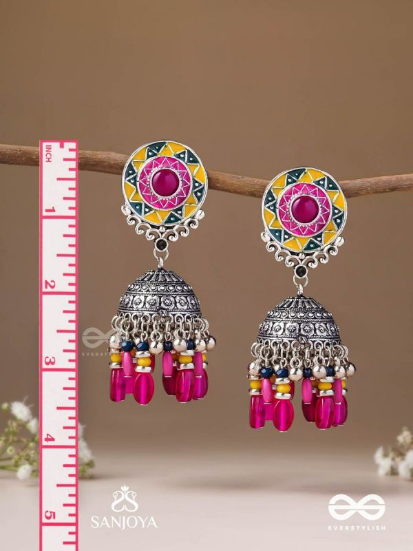Suryaruchi-Sun's Radiance-Lavish pink earrings enamelled with a sun motif and oxidized jhumka adorned with beads and ghunghroos