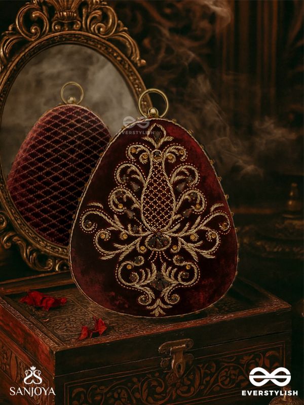 NOOR – OVAL MAROON VELVET CLUTCH WITH RICH ZARDOZI EMBROIDERY AND GOLDEN METAL FRAME