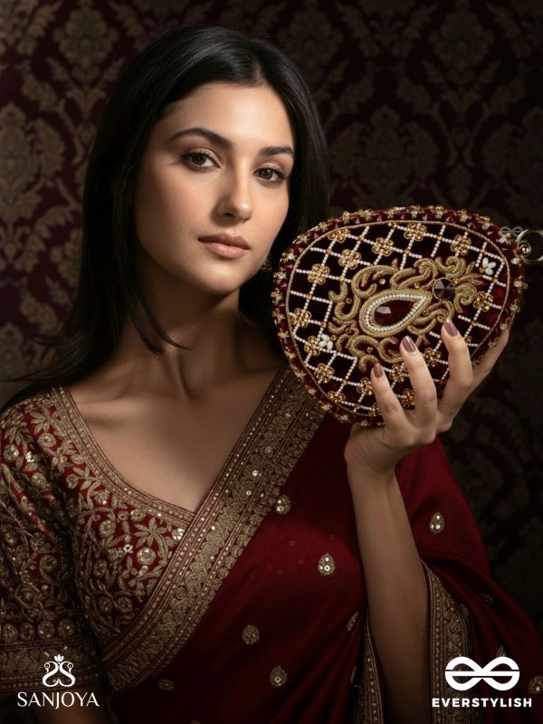 SHAHNAZ – OVAL MAROON VELVET CLUTCH WITH INTRICATE ZARDOZI EMBROIDERY AND GOLDEN METAL FRAME