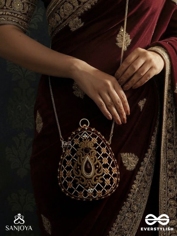 SHAHNAZ – OVAL MAROON VELVET CLUTCH WITH INTRICATE ZARDOZI EMBROIDERY AND GOLDEN METAL FRAME