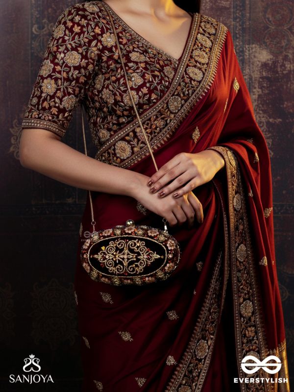 ZEVARIYA – HEIRLOOM-STYLE OVAL CLUTCH WITH INTRICATE ZARI DETAILING AND GOLDEN METAL FRAME