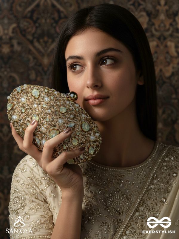 CHANDRAAYA – POLISHED OVAL GOLDEN BRONZE SILK CLUTCH WITH INTRICATE JEWEL STONE EMBELLISHMENT AND GOLDEN METAL FRAME