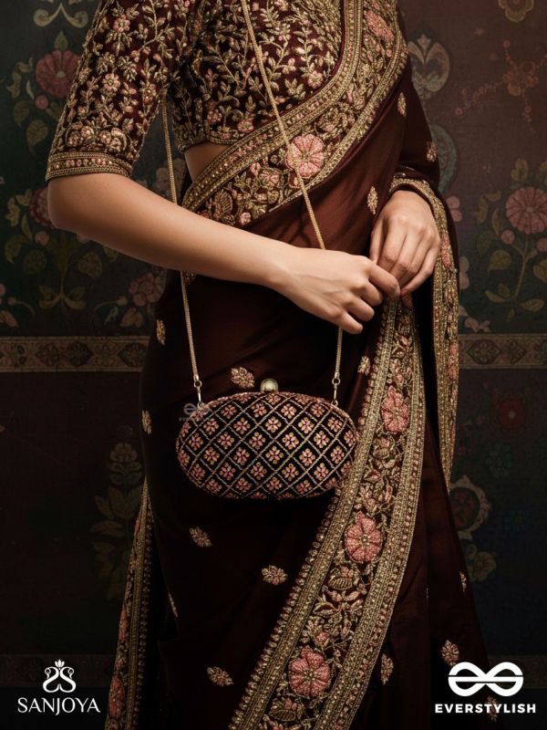 NAZRANA – CURVED MAROON SHADE TEXTILE CLUTCH WITH ORNAMENTED GRID EMBELLISHMENT AND GOLDEN METAL FRAME