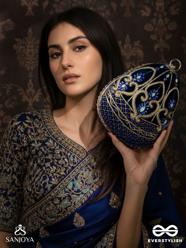 SITARAA – POLISHED OVAL ROYAL BLUE VELVET CLUTCH WITH STONE-ACCENTED HANDWORK AND GOLDEN METAL FRAME