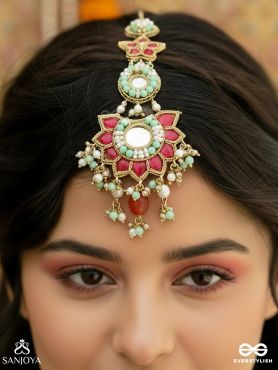 RANGKAMINI – JEWELLED BLOSSOM – ORNATE MAANGTIKA WITH FLORAL MIRROR MEDALLION, RUBY PANELS, TURQUOISE DETAIL AND DANGLING GEM ACCENTS