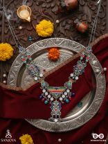 Prema raga- Love colour- Enamelled oxidized neckpiece embellished with beads, mirror and dangling jhumka.