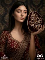 NOOR – OVAL MAROON VELVET CLUTCH WITH RICH ZARDOZI EMBROIDERY AND GOLDEN METAL FRAME