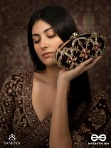 ROHINI – POLISHED BRONZE BROWN TEXTILE CLUTCH WITH FACETED JEWEL ACCENTS AND GOLDEN METAL FRAME