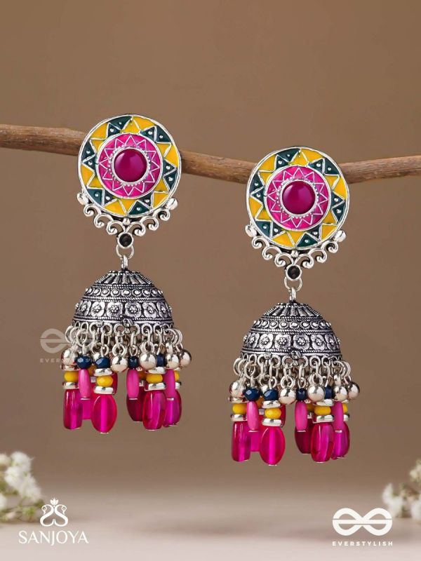 Suryaruchi-Sun's Radiance-Lavish pink earrings enamelled with a sun motif and oxidized jhumka adorned with beads and ghunghroos