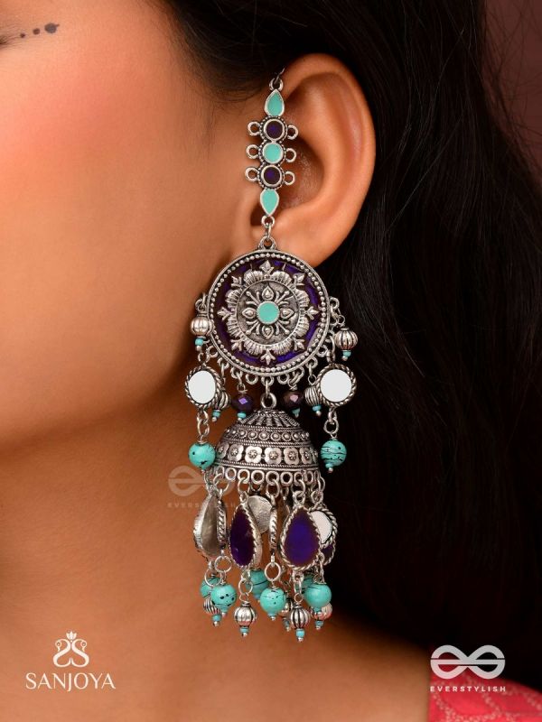 RATNA TILAKA-JEWEL ADORNMENT- EARRINGS ENAMELLED IN SHADES OF BLUE AND BLACK, ACCENTED WITH GHUNGROO BEADS AND OXIDIZED JHUMKI