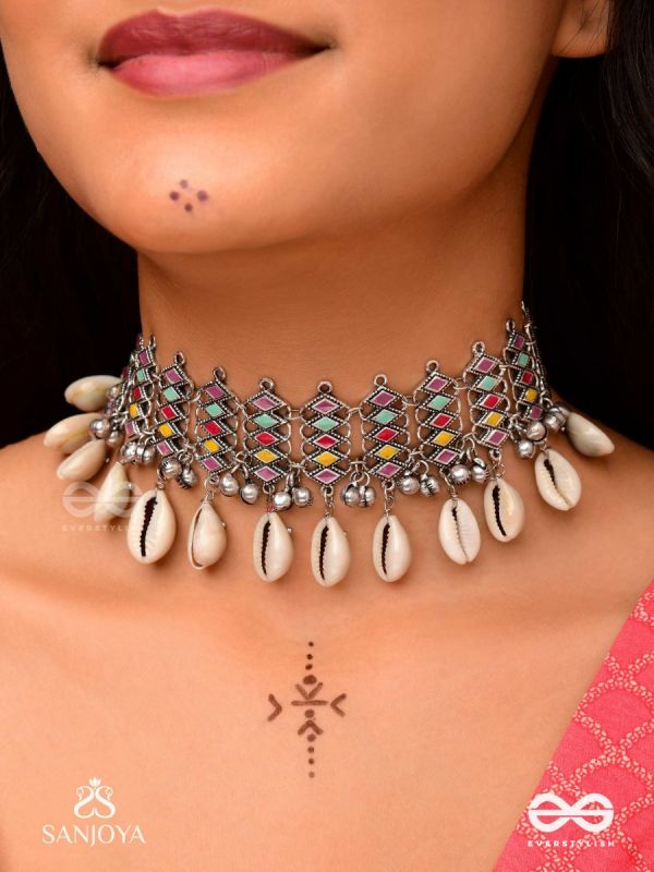 SHANKHAMALA-CONCH GARLAND- OXIDIZED NECKPIECE FEATURING PASTEL-COLOURED METALWORK, EMBELLISHED WITH DANGLING COWRIE SHELLS AND GHUNGROO'S